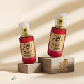 Two red perfume bottles with gold caps on a beige background