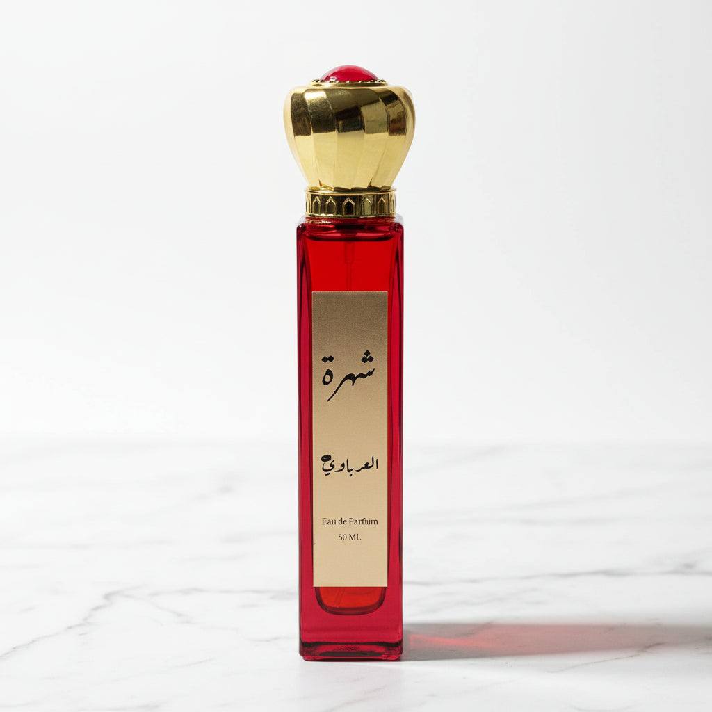 Red perfume bottle with gold cap on a white surface