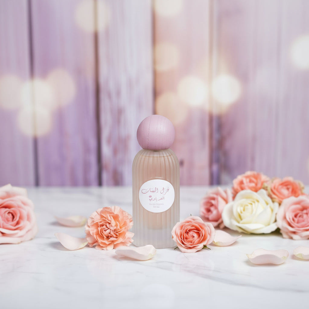 Perfume bottle with a pink cap on a soft, blurred background with flowers.