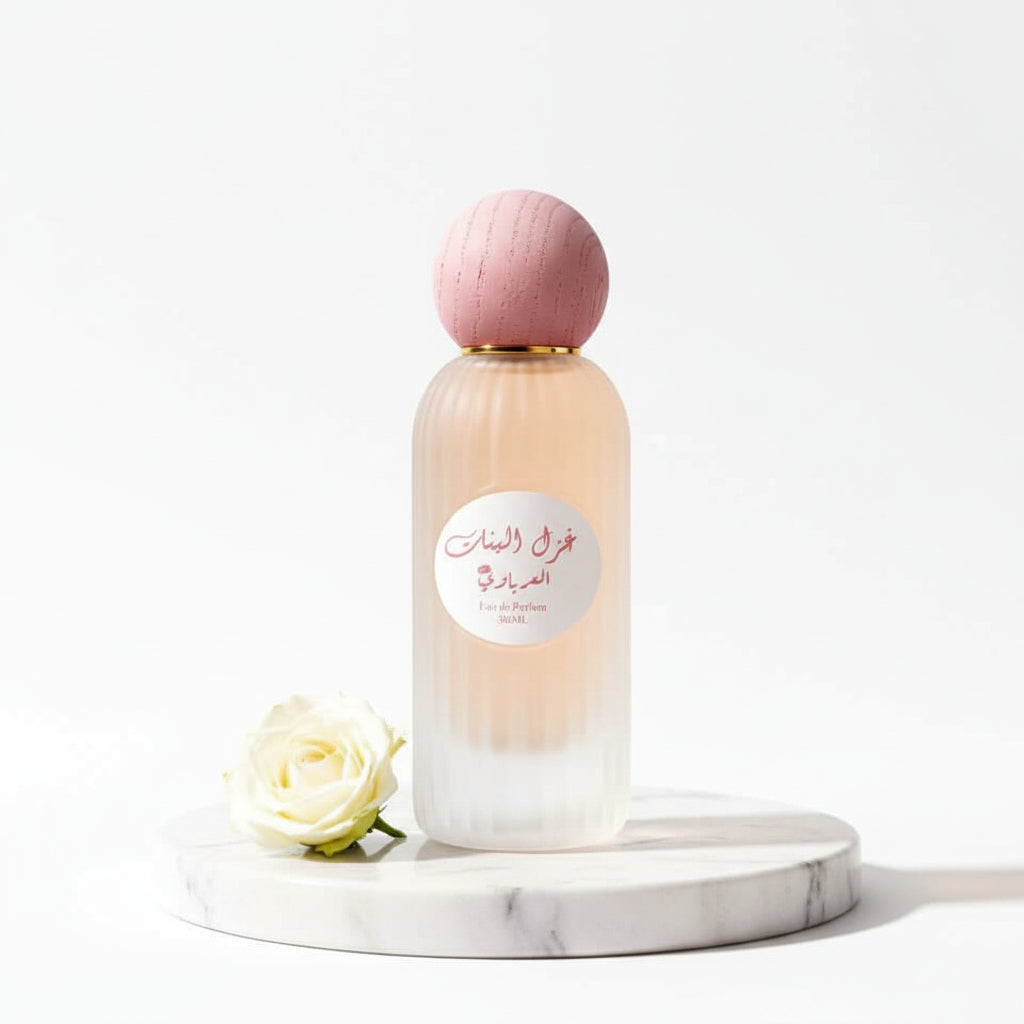 Perfume bottle with pink cap and white label on a beige background